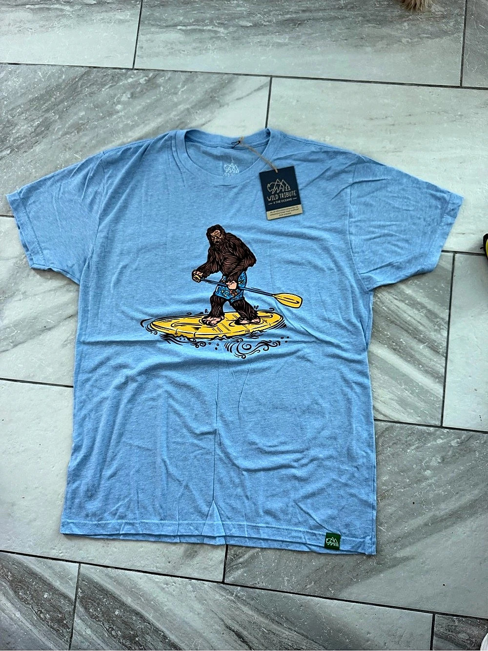 Wild Tribute Sasquatch Paddle Board Graphic Short Sleeve T-Shirt in Blue Size L